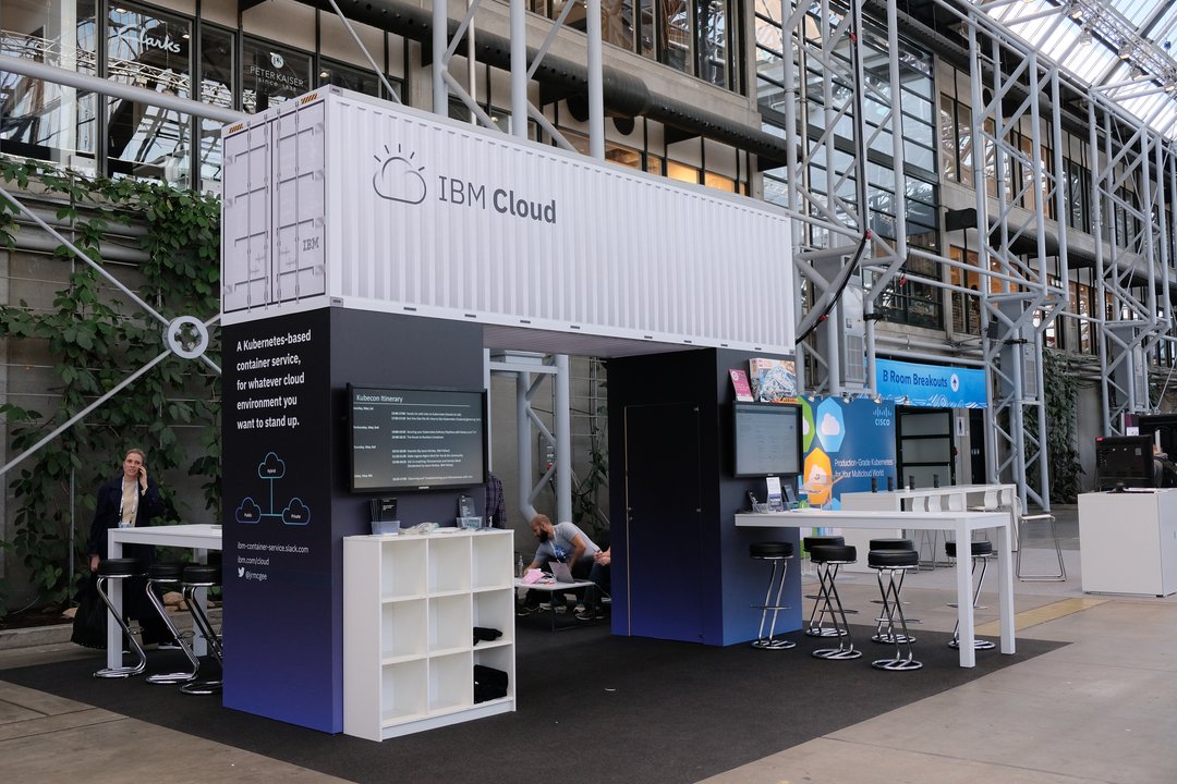 An empty shipping container probably made of cardboard hanging over the IBM booth